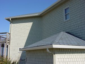 A house with seamless gutters and light color siding.